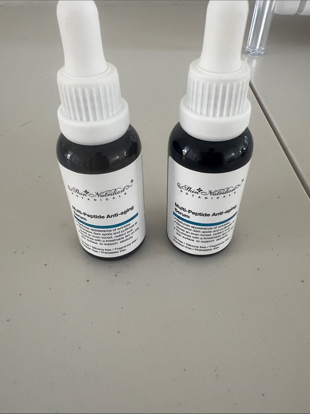 adidas white and black dropper serum bottles